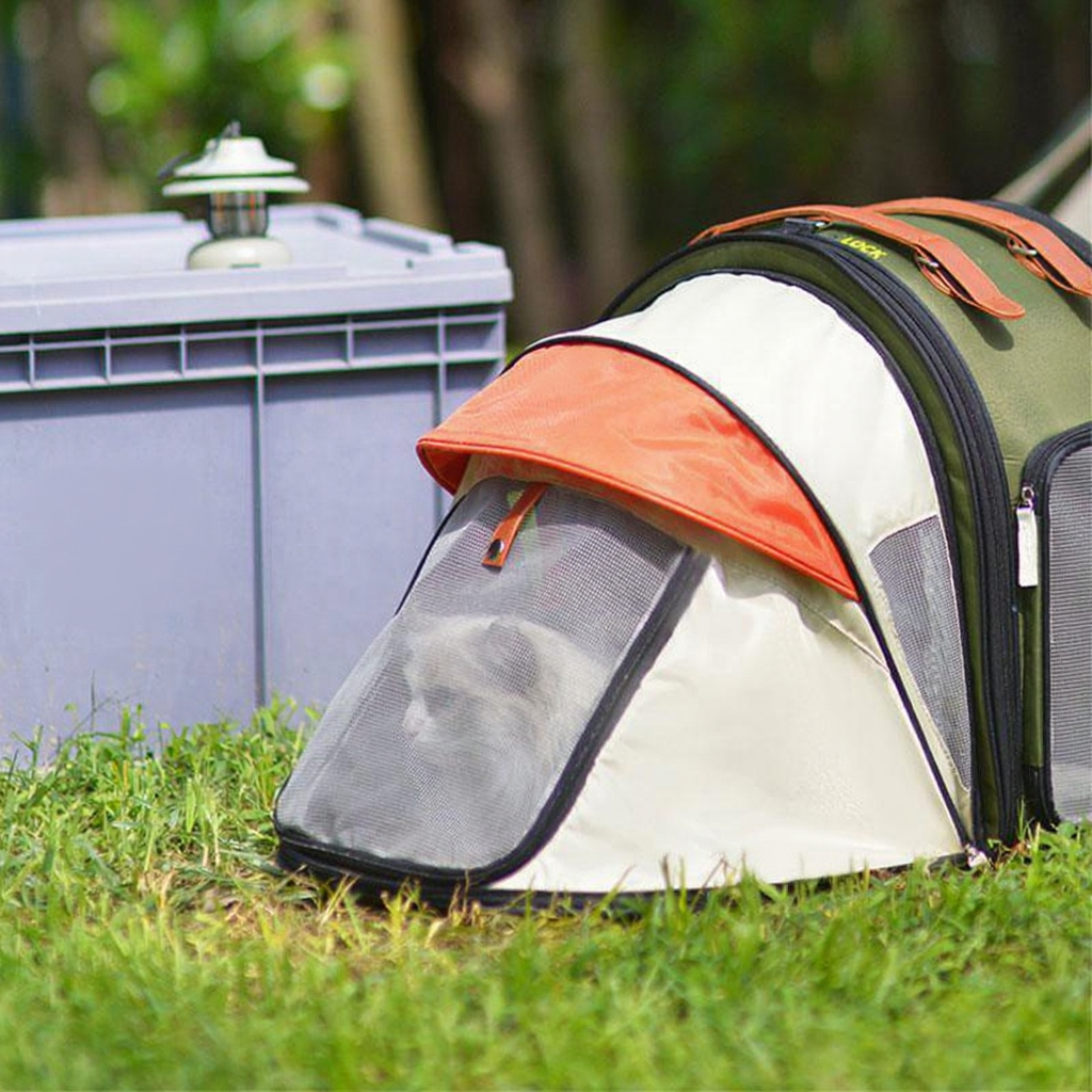 Catvera Foldable Cat Carrier Tent - Image 7|||PROMPT|||Cleaned image. Original analysis: Found multiple brand names and logos: 'SERENDIPITY', 'SOMNAMBULIST', 'EPOCH' text on the purple cooler/container on the left side, and 'PUFF' text on the orange hood/canopy of the pet carrier on the right, plus what appears to be a brand logo on the bottom right of the carrier.