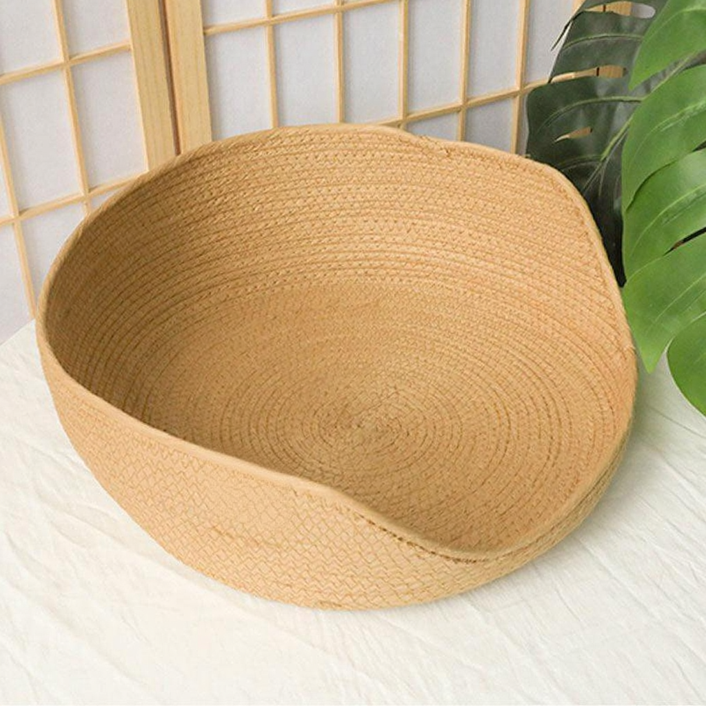 Catvera Handwoven Cooling Cat Bed - Image 1|||PROMPT|||Cleaned image. Original analysis: Found 1 brand logo patch stitched onto the product - a rectangular orange/terracotta colored label with brand initials on the front lower left area of the basket