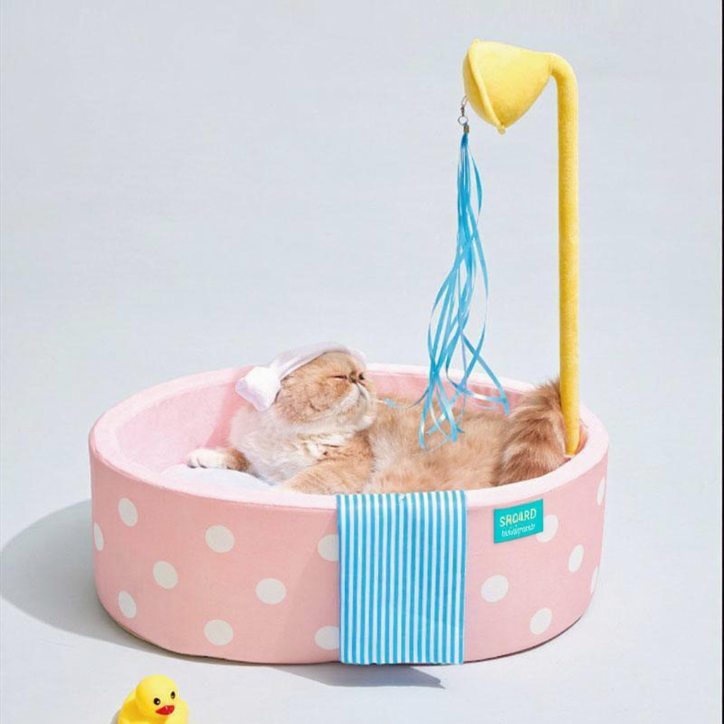 Catvera Japanese Hot Spring Cat Bed - Image 13|||PROMPT|||Cleaned image. Original analysis: Found 1 brand name/logo on the product - a small brand label/tag visible on the side of the pink bed where the blue striped fabric attaches