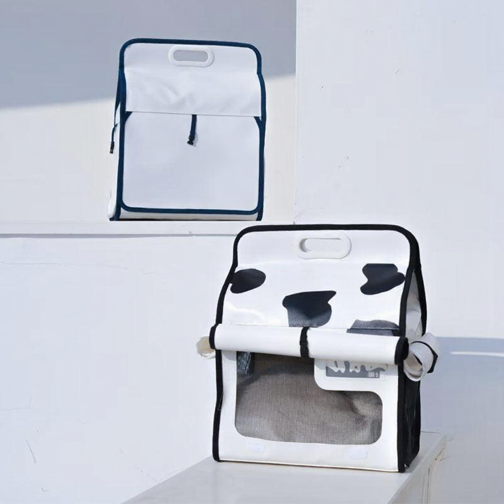 Catvera Milk Carton Cat Carrier - Image 16|||PROMPT|||Cleaned image. Original analysis: Found 1 brand name printed on the product. The upper bag displays 'milk' text vertically on its front face. The lower bag contains a cow spot pattern which is decorative, not branding.